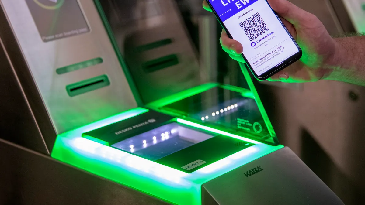 Air travel passenger uses CommonPass app to verify health status pre-flight