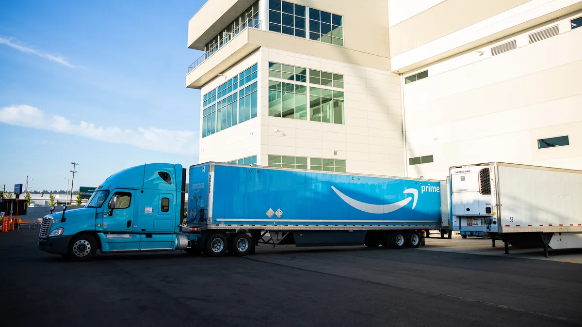 An Amazon Prime delivery truck sits at a facility.