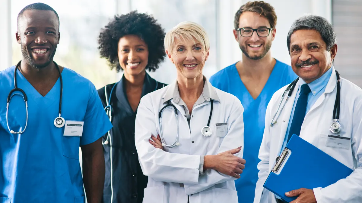 A portrait of a a team of nurses and doctors in their uniforms.