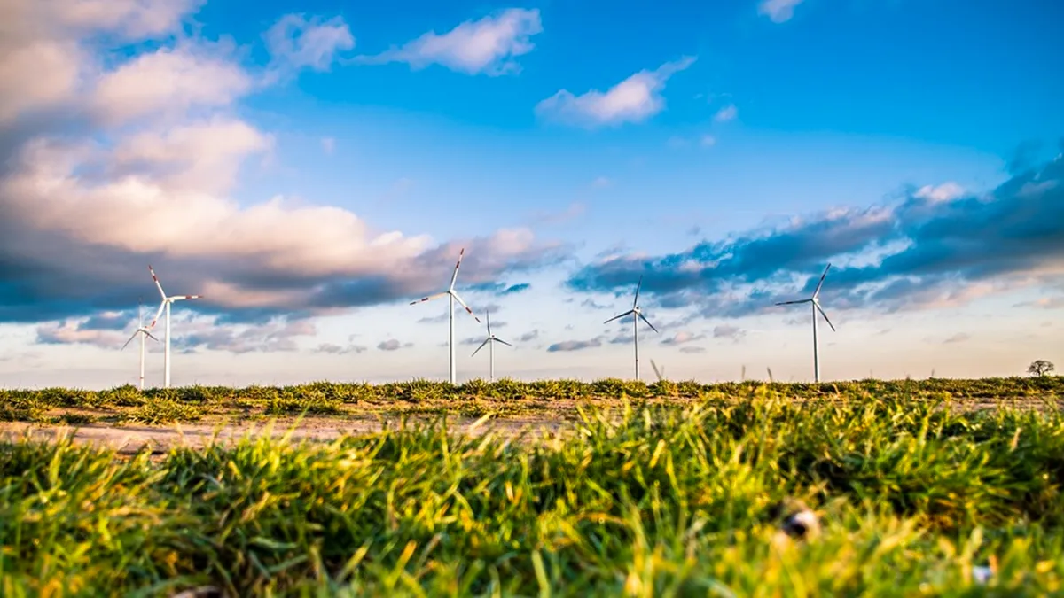 This image shows several wind turbines operating over a grass prairie in Texas.