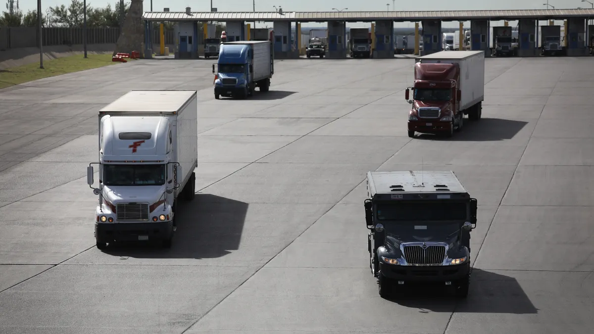 Trucks, including an armored car, pass through U.S. customs on October 17, 2016 in Laredo, Texas.