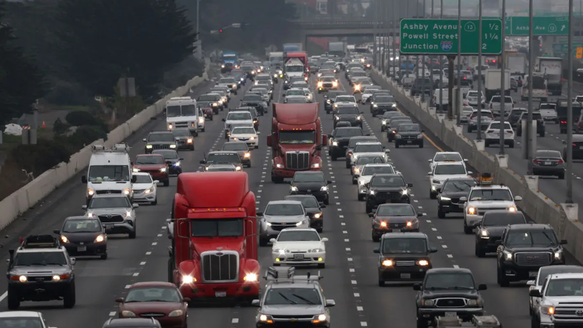 Bumper to bumper cars and trucks on a five-lane highway.