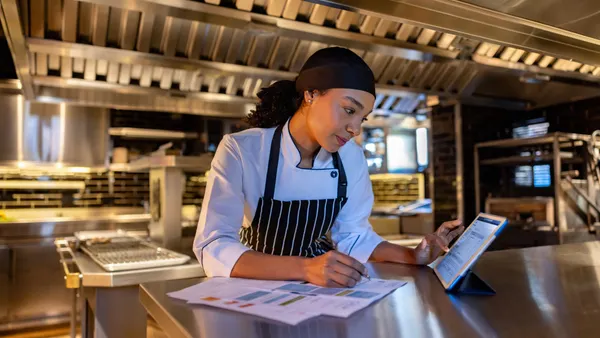 Chef paying bills in the kitchen