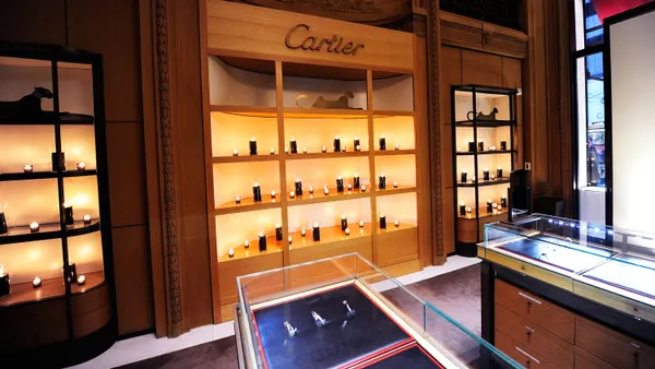Interior of a Cartier store shows display cases.