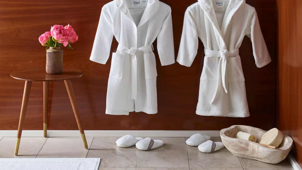 Two white robes and two pairs of white slippers.