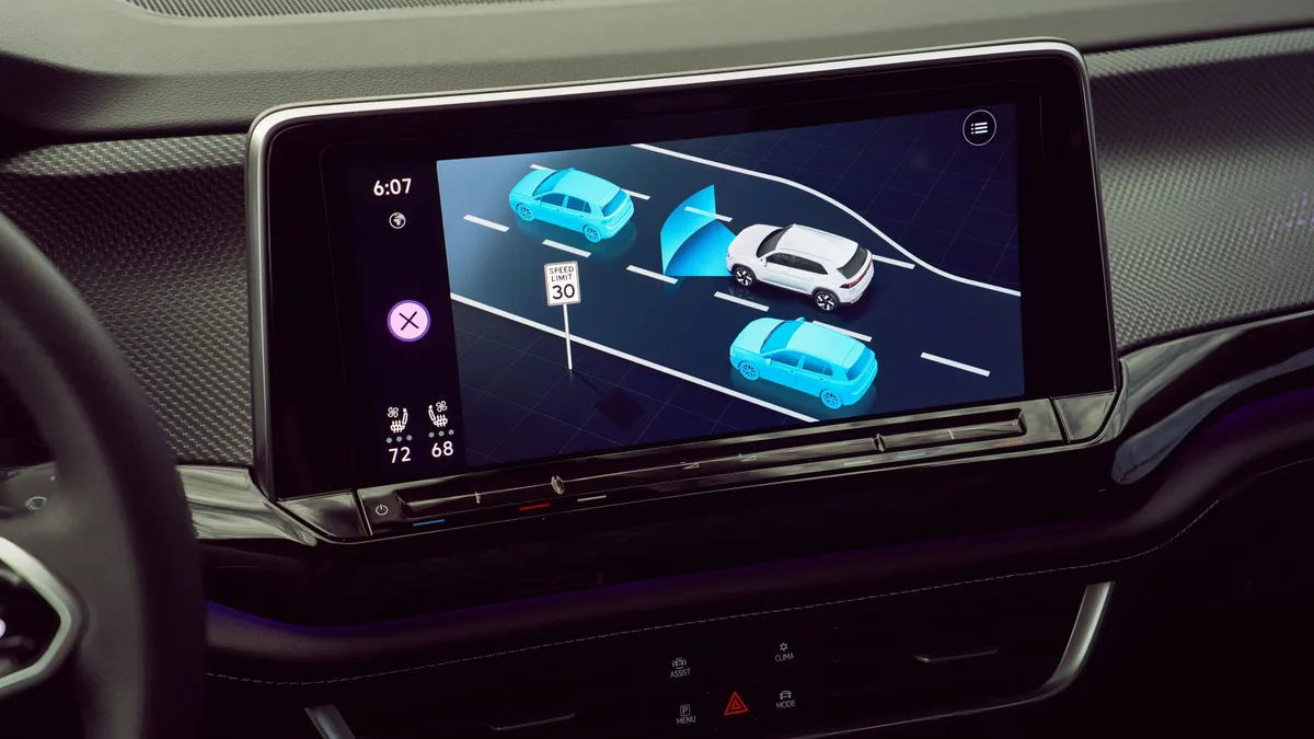 The infotainment screen of the 2024 Volkswagen Atlas Cross Sport SUV showing nearby vehicles with adaptive cruise control engaged.