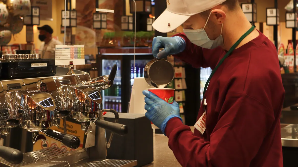 Employee making a drink at The Buzz Coffee Shop at the Wegmans store in Tysons, Virginia