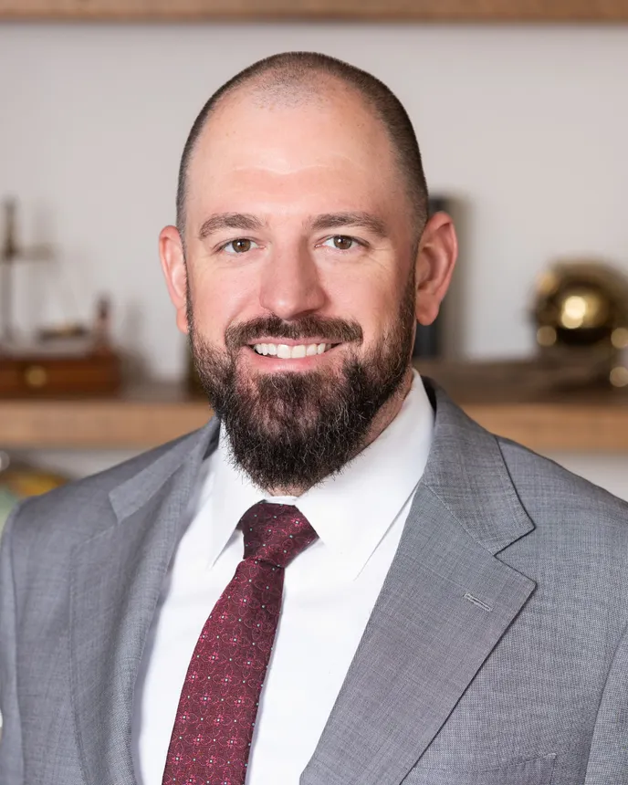 Headshot of a man in professional attire.
