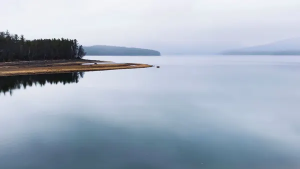 A large body of water with mountains in the background.