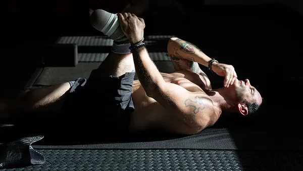 A veteran with an amputed leg does yoga in the morning light