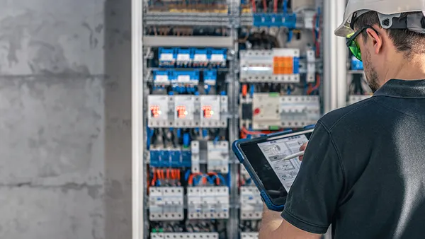 Electrician working on electrical fuses.