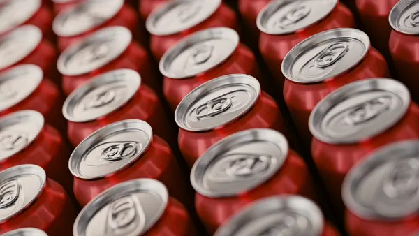 The tops of cans of Coca-Cola