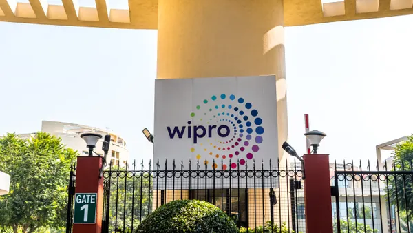And outdoor shot of Wipro's logo on a sign behind a fancy fence in front of the IT services firms' campus in Kolkata, India.