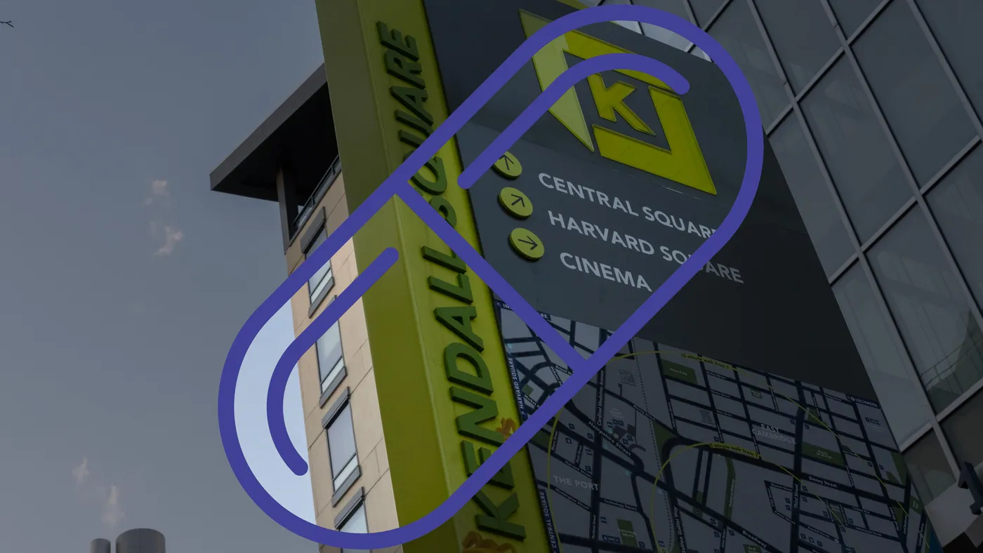 A view of a sign that reads, "Kendall square: central square, Harvard square, cinema" is framed by a pill outline.