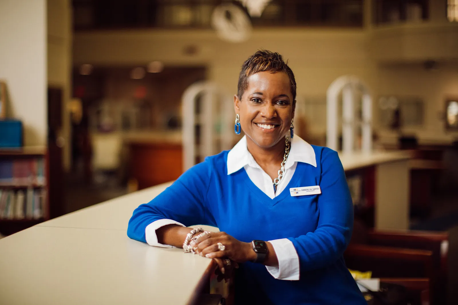 A woman superintendent is seated in a library for a portrait.