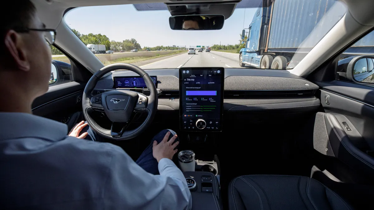 A driver using Ford's BlueCruise automated driving feature on a highway in a 2022 Mustang Mach E.