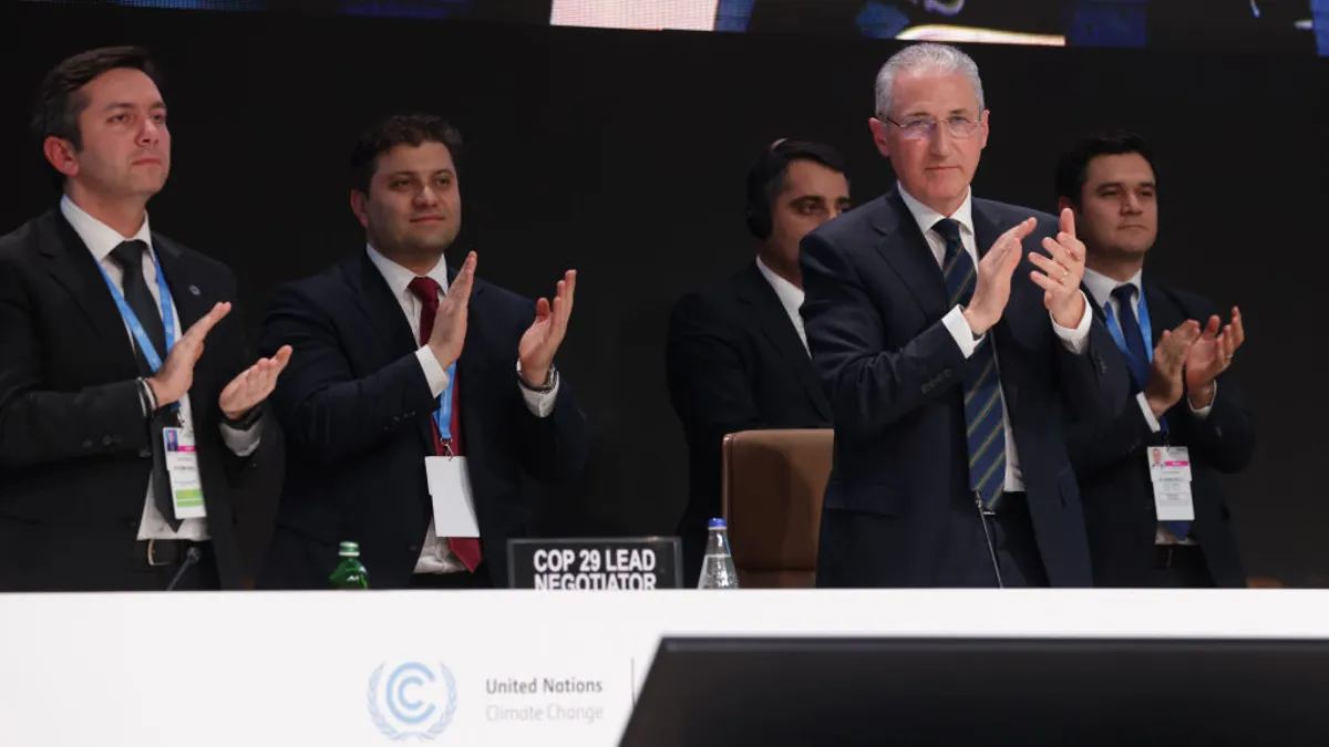 COP29 delegates and negotiators seen clapping.