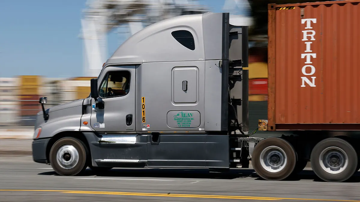 A truck drives through an ocean port in California.