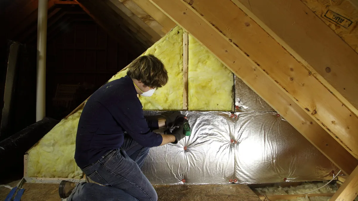 attic insulation being installed