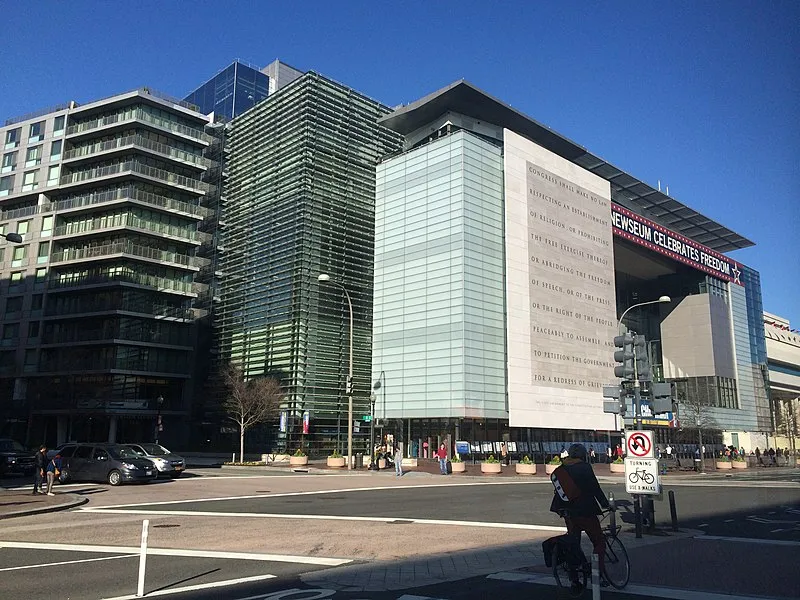 A photo of a large, modern building taken from the street.