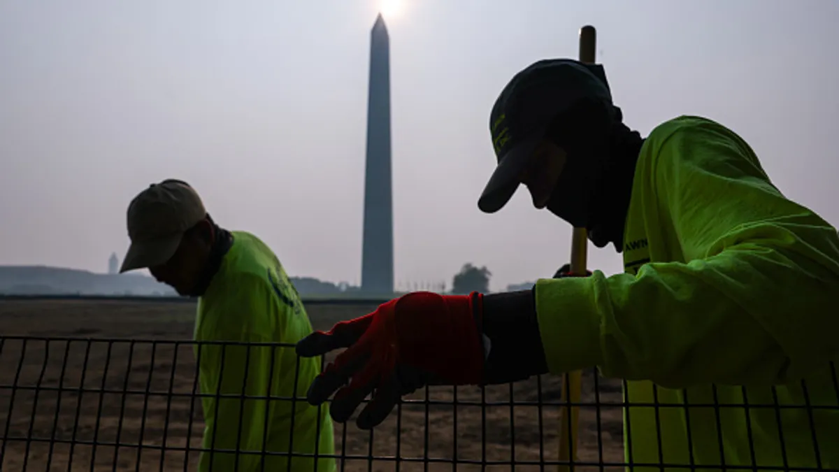 Workers tend to the National Mall amid smoke from massive wildfires
