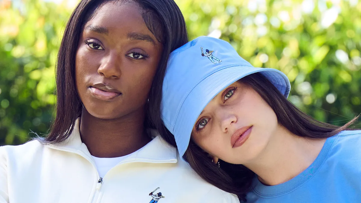 Two people wearing items from Eastside Golf's women's line.