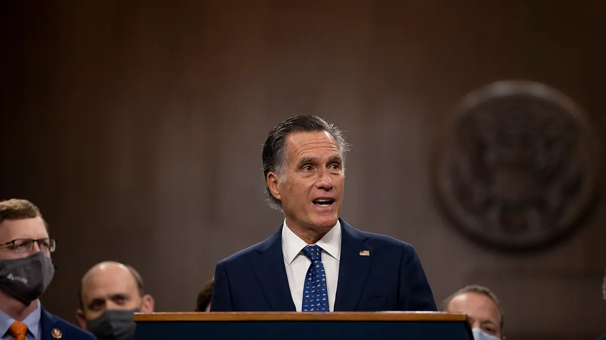 Mitt Romney stands at a podium