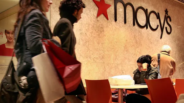 Customers exit a Macy's store.