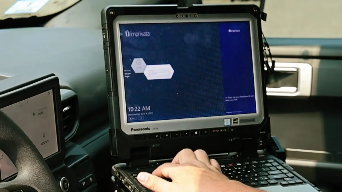 Laptop open and user is accessing software