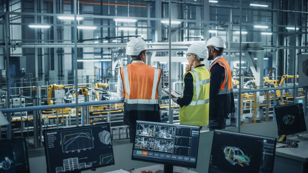 Young Diverse Team of Automotive Engineers Working in Office at Car Factory.