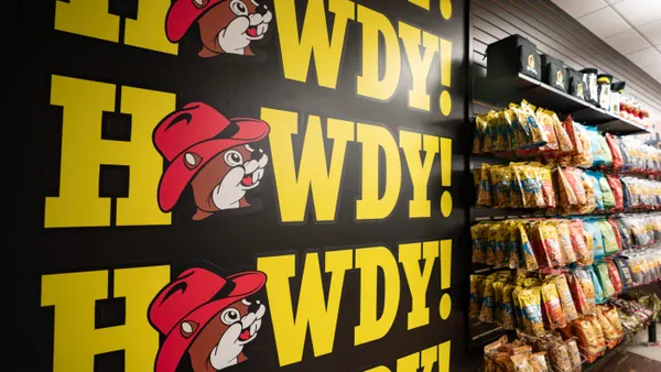 A photo of a display of merchandise inside a store. A sign on the wall says "Howdy" multiple times with a picture of a beaver in a hat in place of the "O".