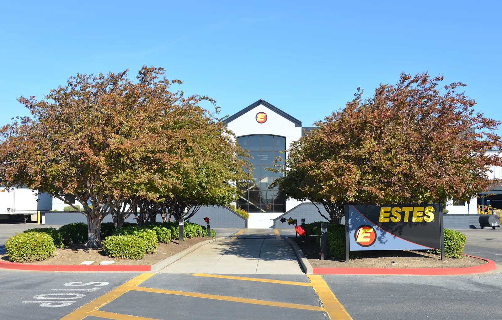 The entrance of an Estes facility in Tracy, California, showing the carrier's logo on a sign.