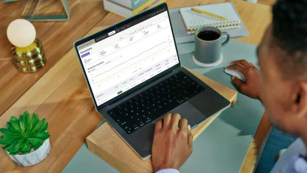 Person sitting at desk working on their laptop.