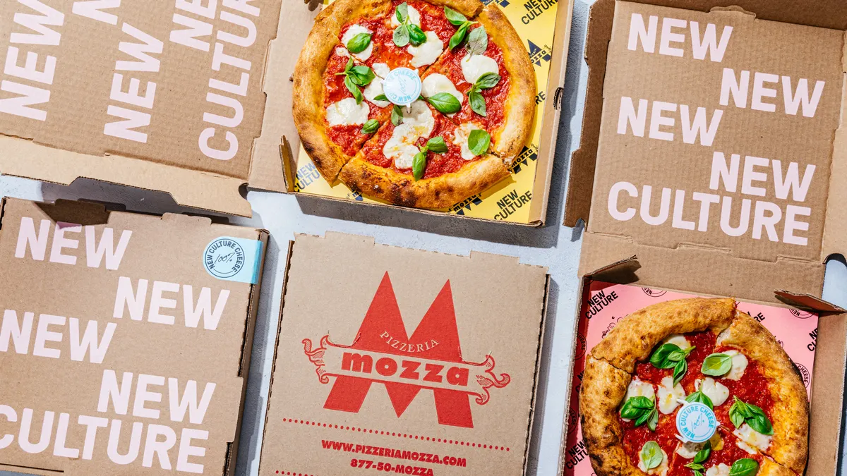 Four boxes of pizza with New Culture and Pizzeria Mozza logos. Two open boxes have pizzas featuring melted mozzarella pieces and basil