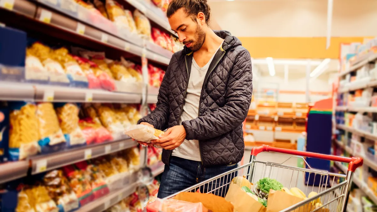 Shopper examines package in a supermarket.