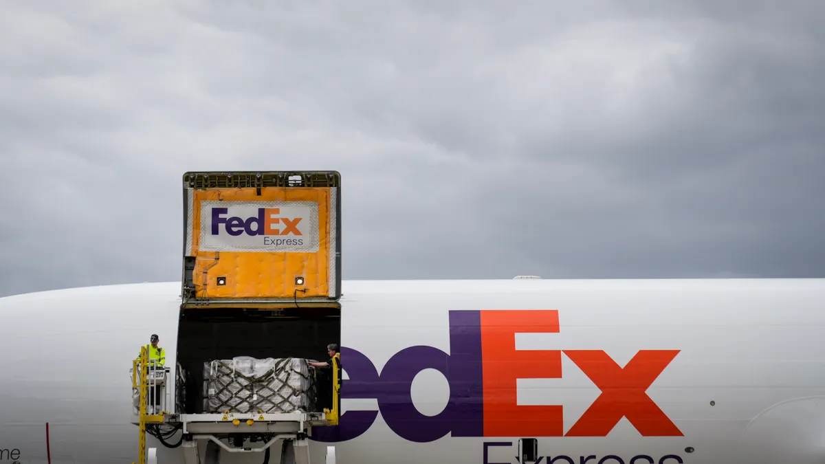 Pallets of baby formula are unloaded from a FedEx cargo plane upon arrival at Dulles International Airport on May 25, 2022, from Ramstein Air Base in Germany.