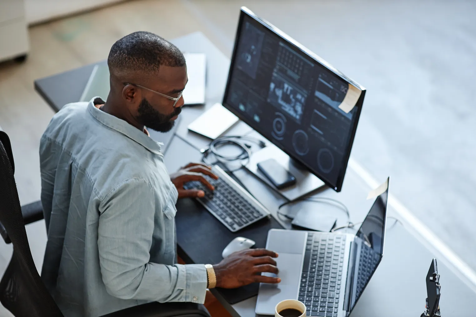 Person working with computers and data systems in office