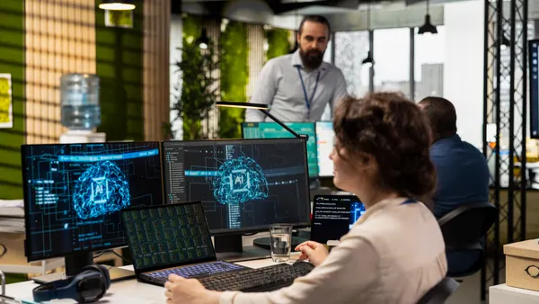 Office administrator checking monthly reports with AI analytics platform, employing neural networks algorithms and automation for business productivity. IT company representative at work.