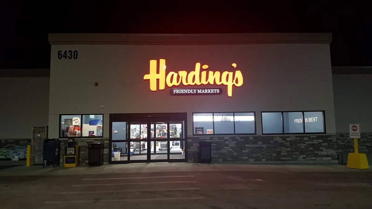 Exterior of Harding's Friendly Markets grocery store at night