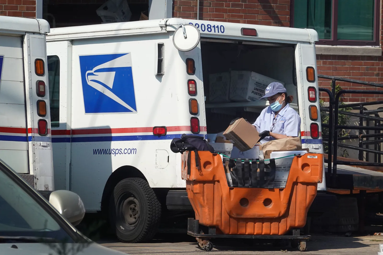 A postal worker loads a delivery truck on October 1, 2021 in Chicago, Illinois.