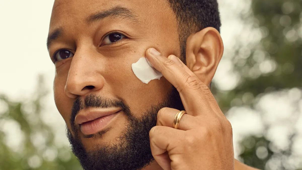 John Legend applying a Loved01 product.