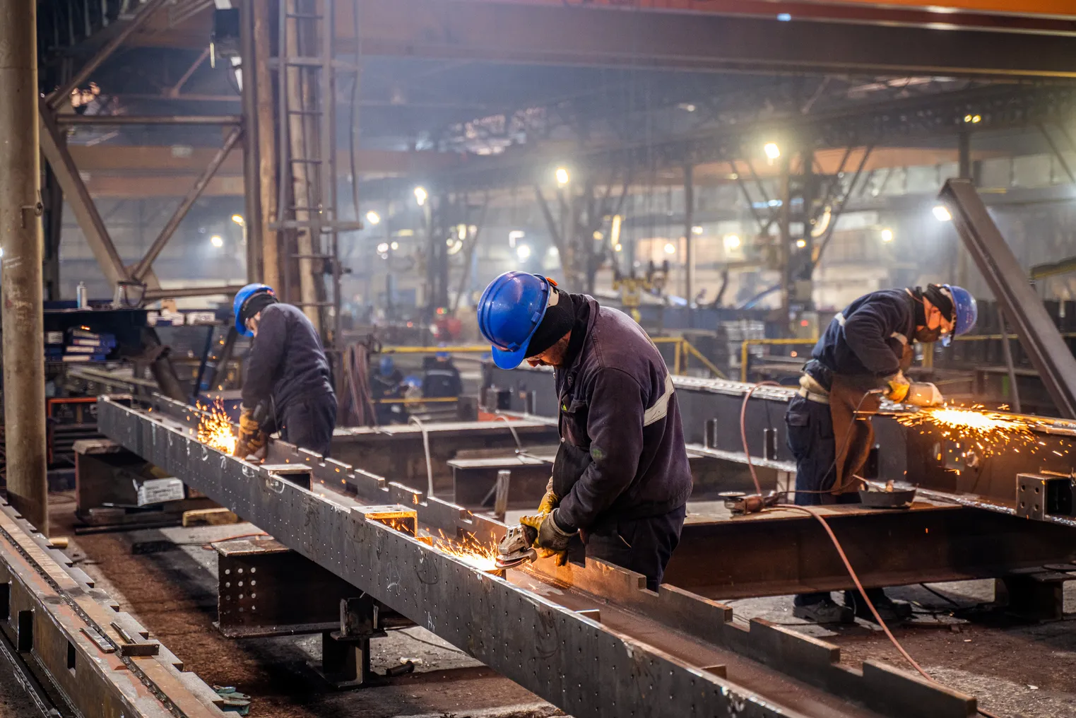 Workers in a factory for metal production.