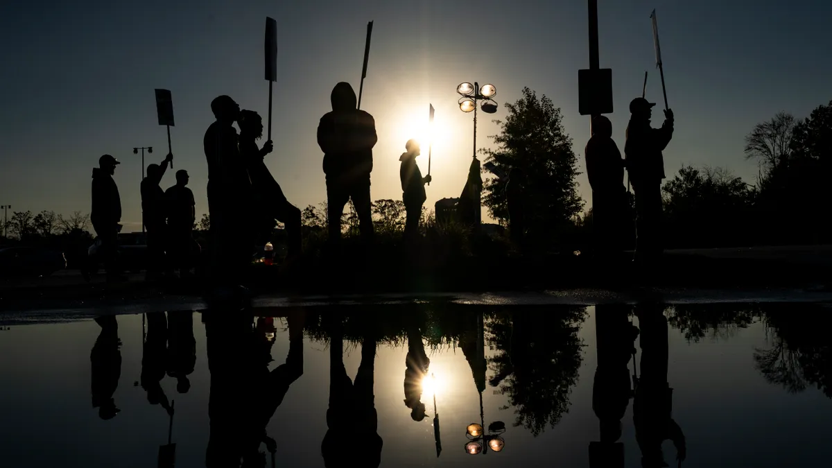 Factory workers and UAW union members form a picket line outside the Ford Motor Co. Kentucky Truck Plant in the early morning hours on October 14, 2023 in Louisville, Kentucky.