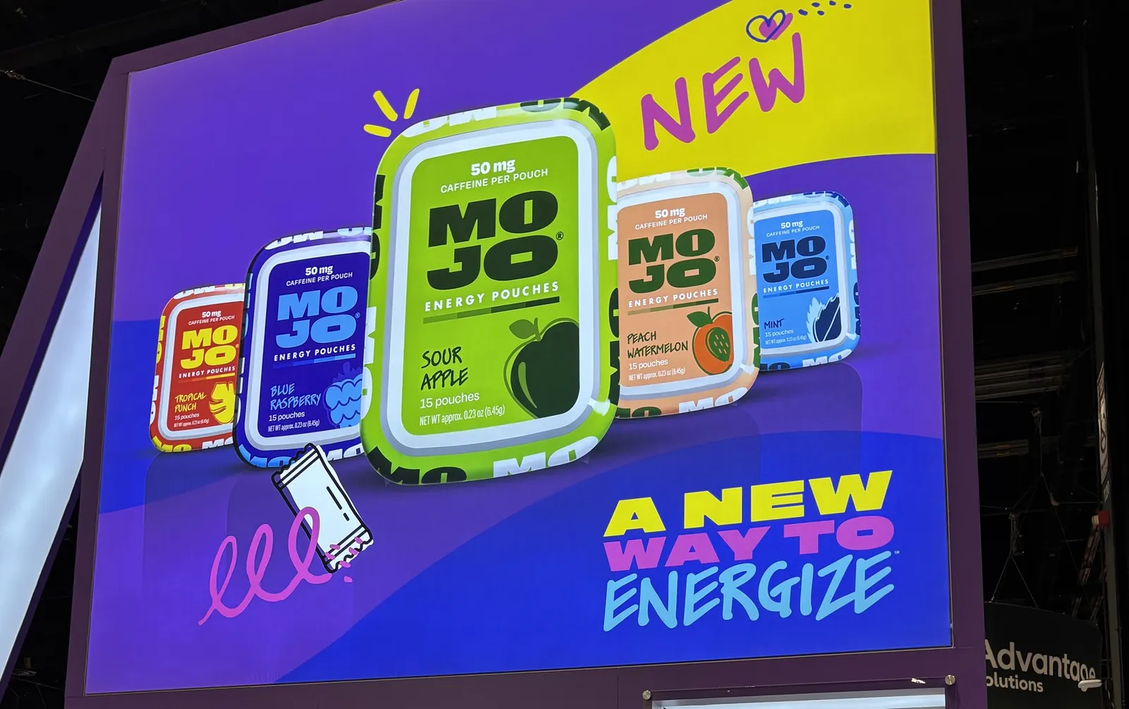 A photo of an advretisement that reads "New. Mojo energy pouches. A new way to energize." Alongside pictures of tins in various colors.