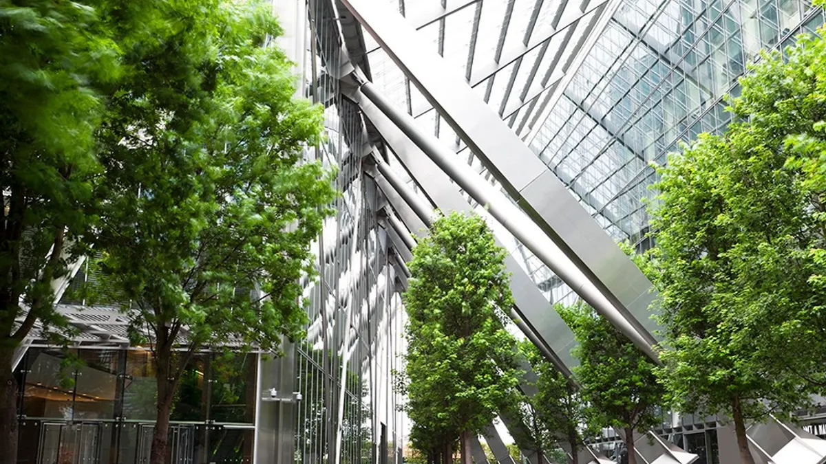 Trees and Office Buildings in a city walkway.