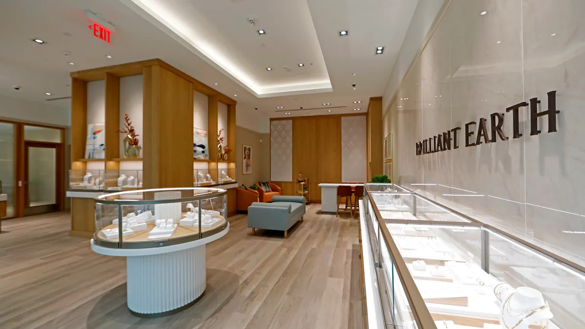 Interior of a Brilliant Earth showroom in New York featuring wood flooring and white jewelry display cases