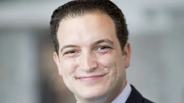 Medtronic's Jason Fontana is wearing a blue suit and blue patterned tie in a headshot.