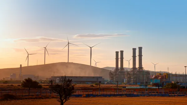 Silhouette of Natural gas processing plant with Renewable energy wind turbines generating electricity