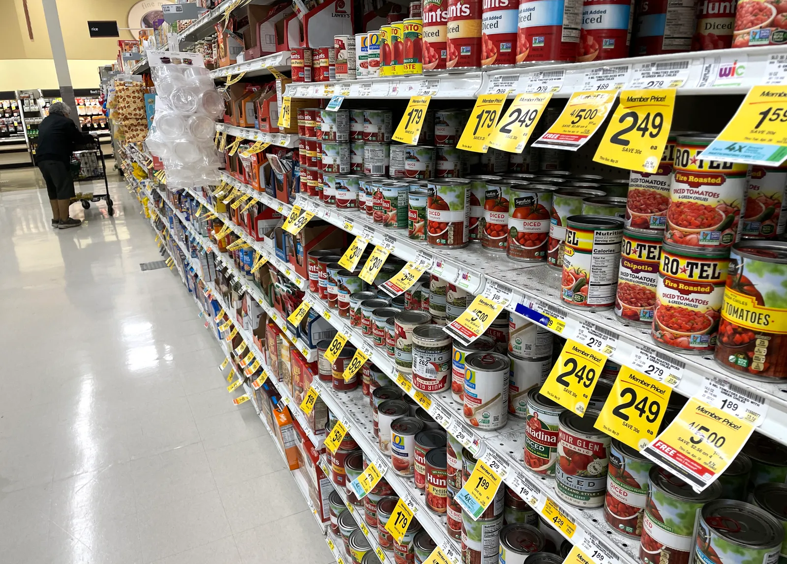 A grocery store aisle with multiple types of canned goods on sale