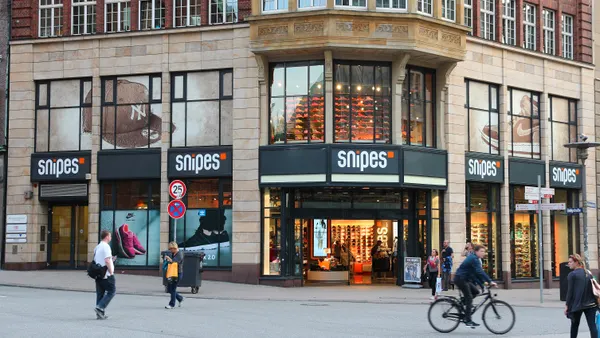 People walk outside a Snipes store.